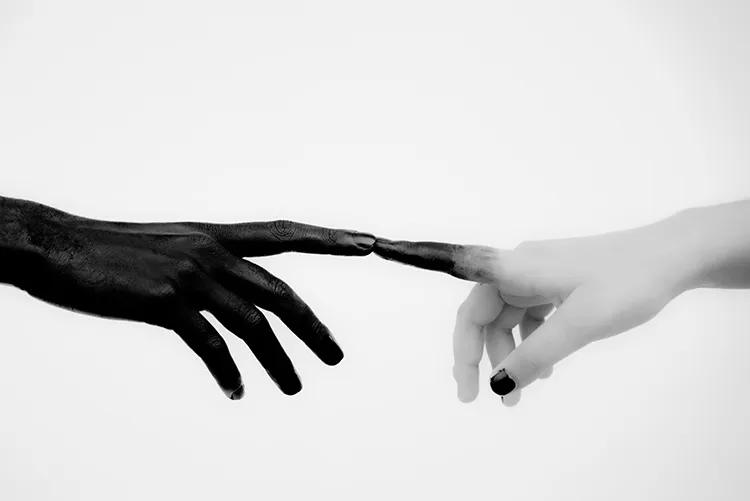 two hands reaching for each other